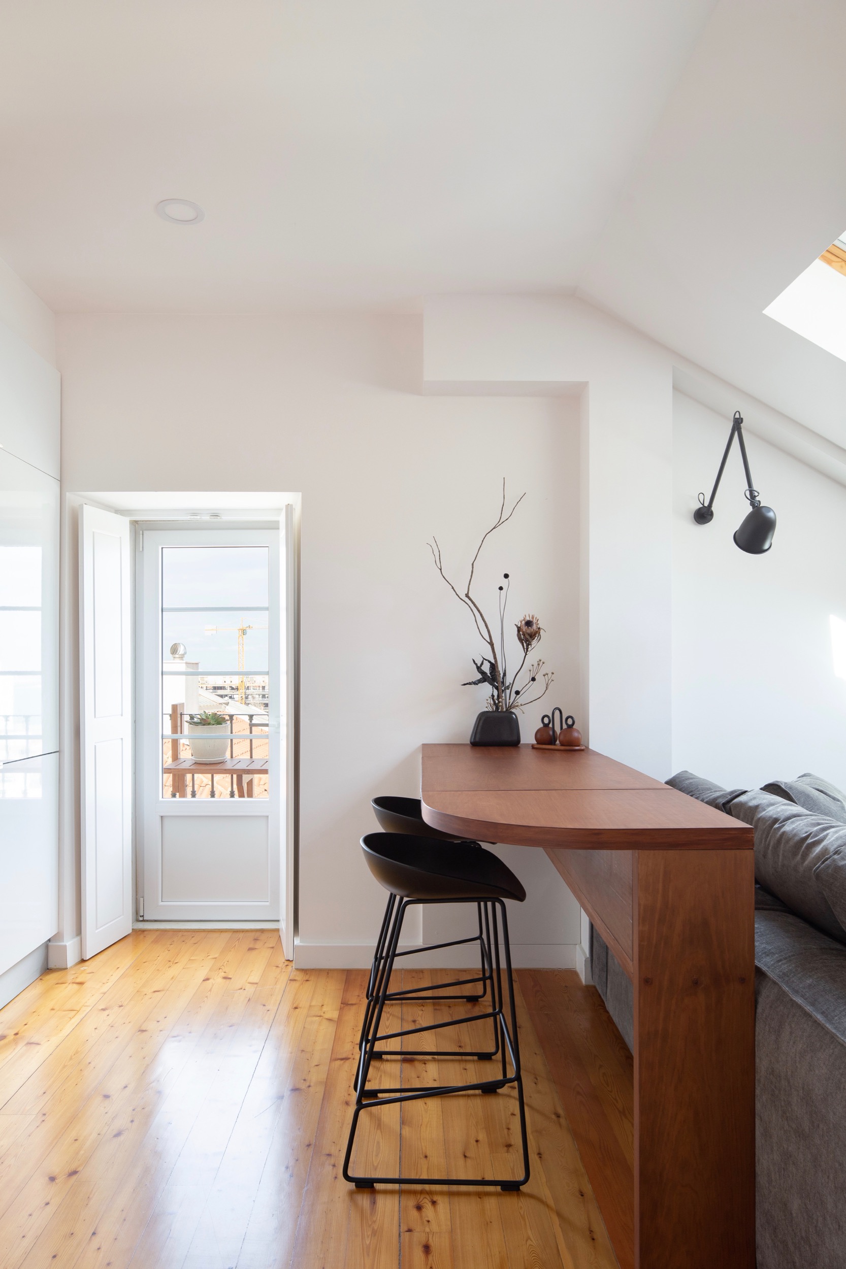 Photo of Lola Cwikowski Interior Design Studio's Travessa da Pereira Apartment project, showing custom breakfast bar with built-in drawing table. Photograph © Alexander Bogorodskiy